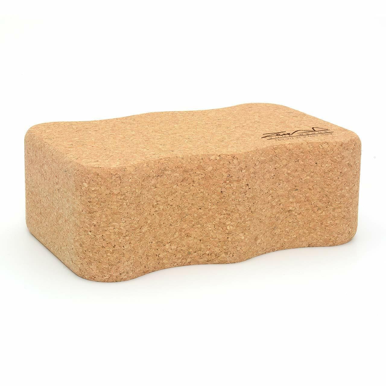 Cork yoga block side profile displaying curved ergonomic shape for optimal support and comfort